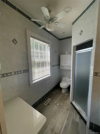 a bathroom with a toilet sink and a shower