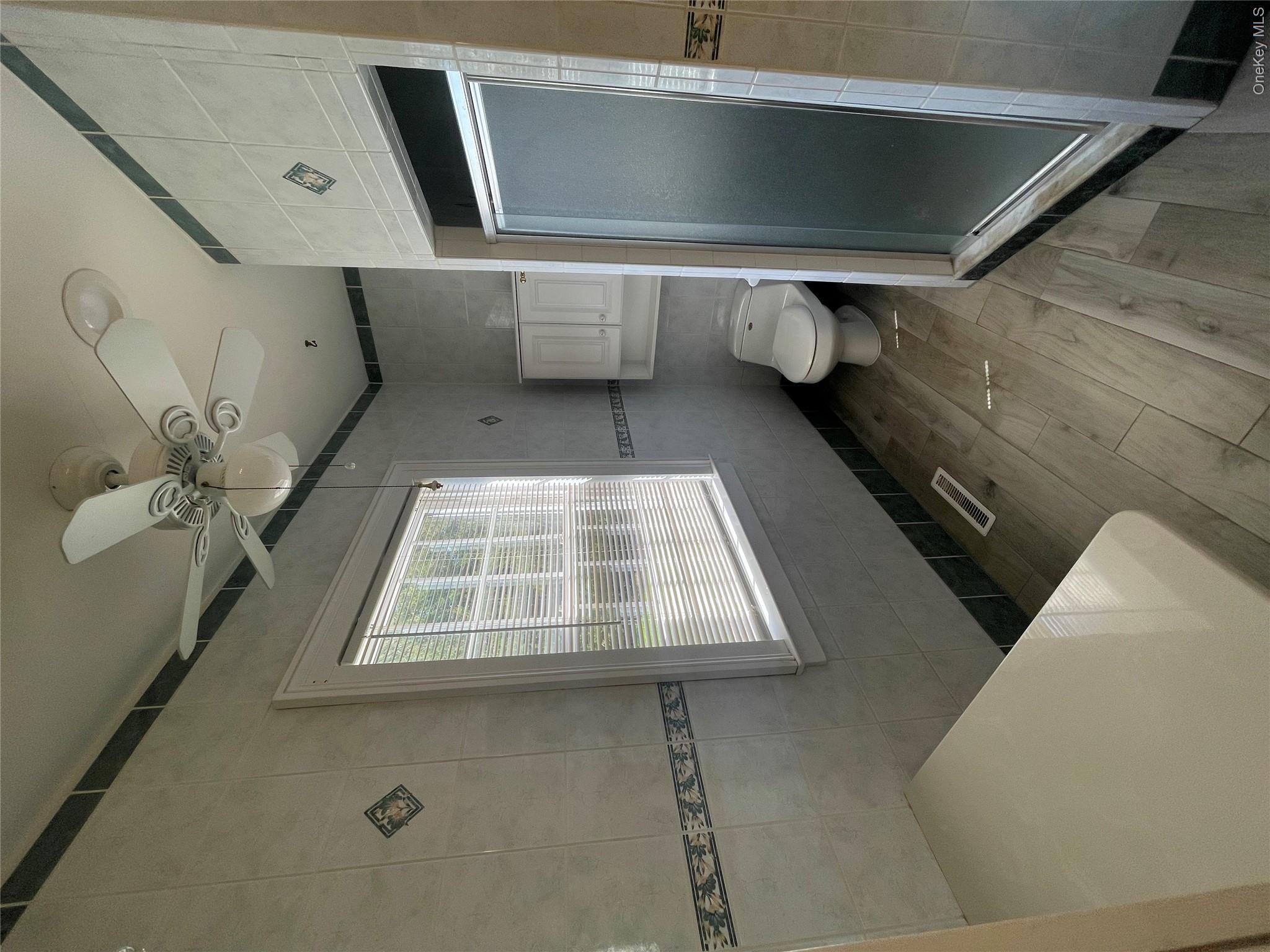 496 North Country Road St. James, NY 11780 - Photo 9 of 18 a bathroom with a toilet sink and a shower