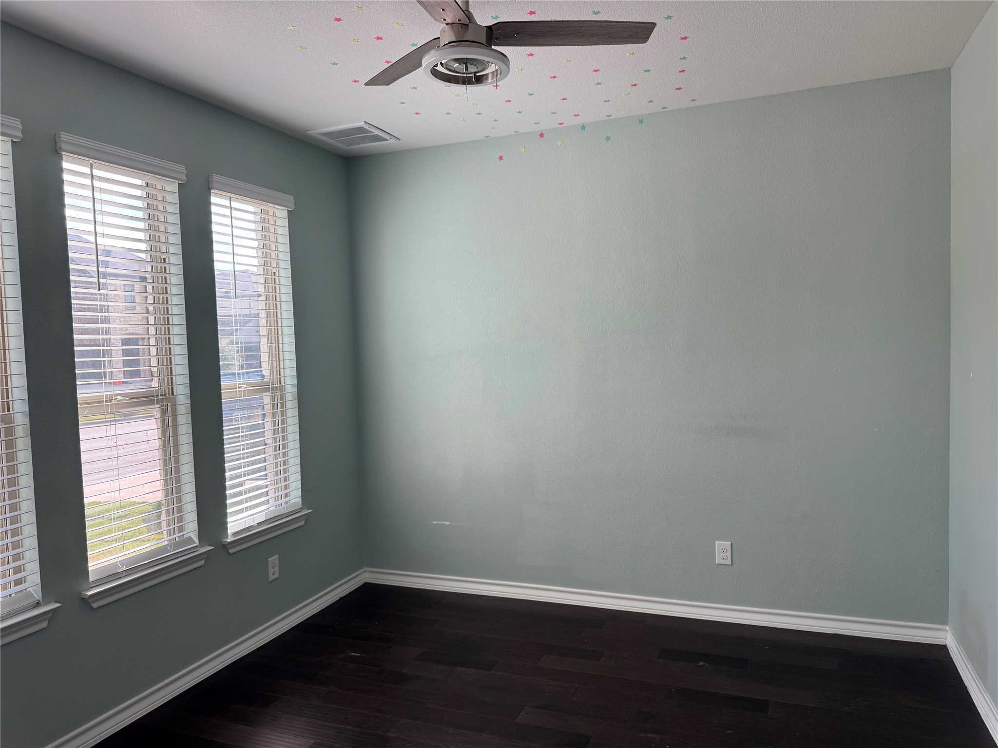 333 Capstone Road Liberty Hill, TX 78642 - Photo 3 of 40 Empty room featuring dark wood finished floors and a ceiling fan