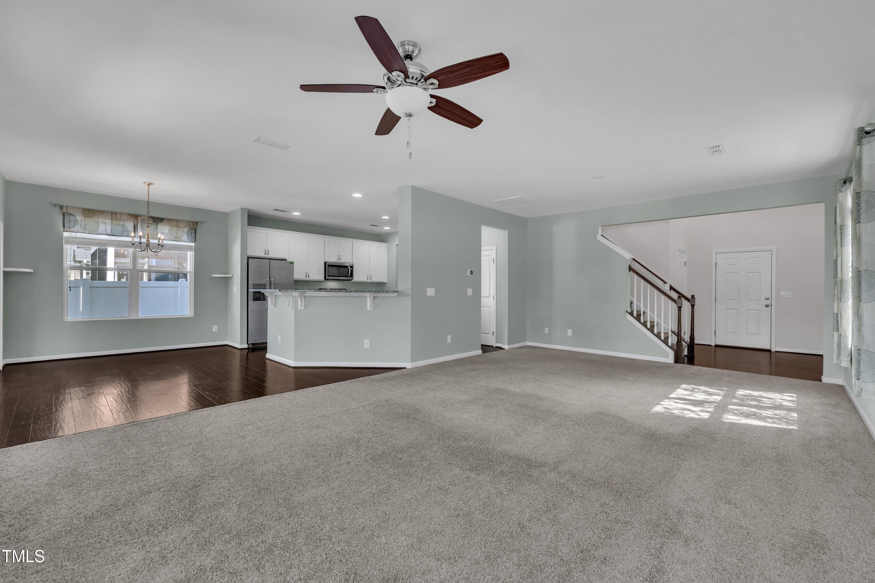 3519 Winding Walk Court Raleigh, NC 27616 - Photo 15 of 43 a view of an empty room with a window and kitchen view