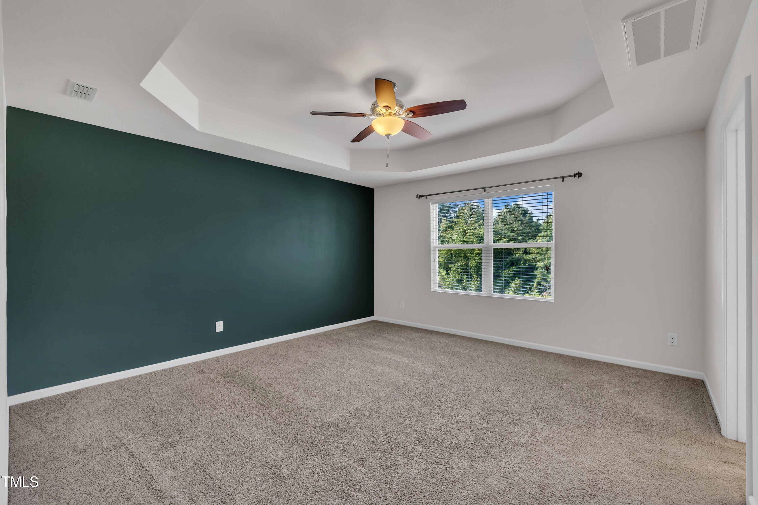 3519 Winding Walk Court Raleigh, NC 27616 - Photo 17 of 43 an empty room with windows and fan