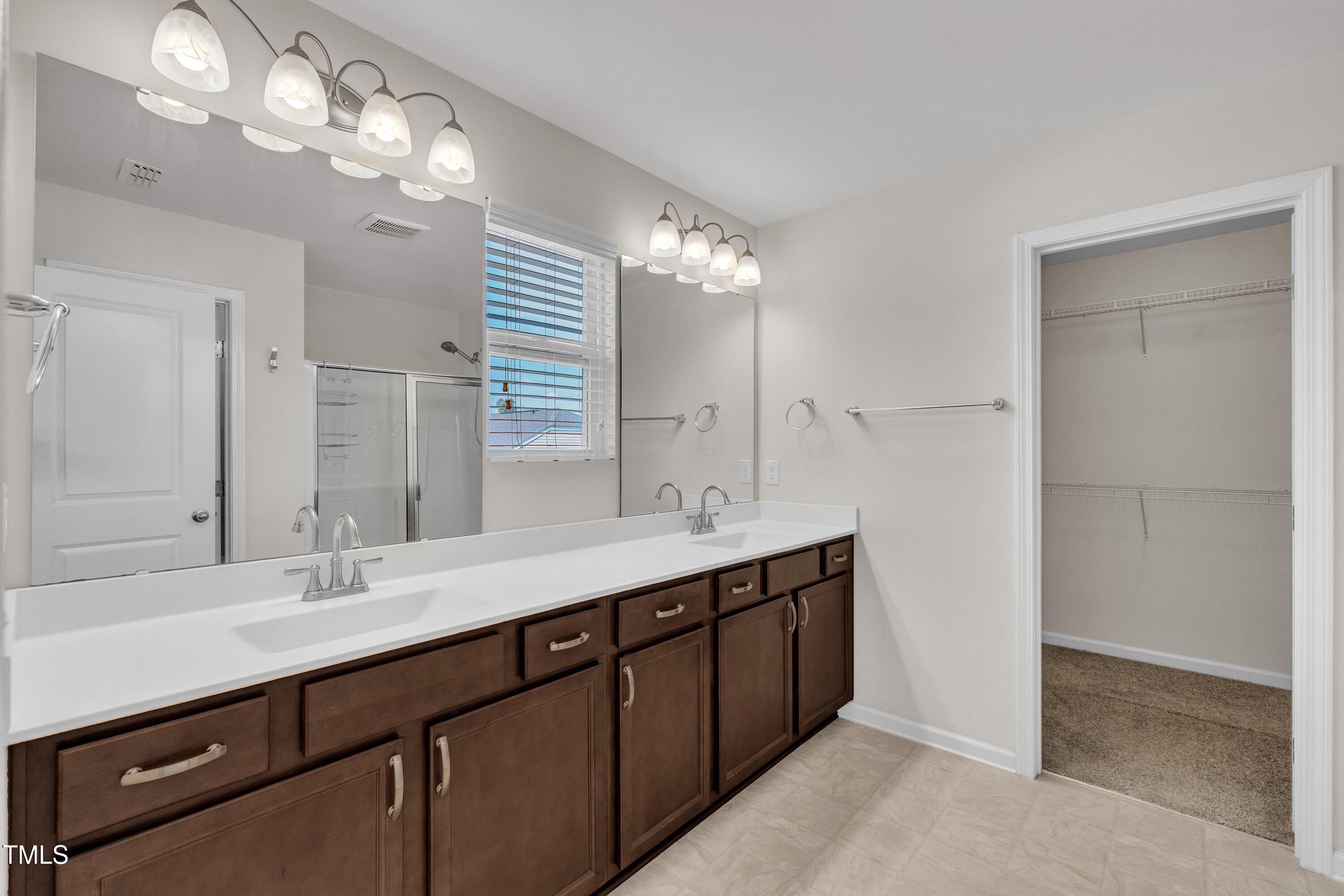 3519 Winding Walk Court Raleigh, NC 27616 - Photo 20 of 43 a bathroom with double vanity and a mirror