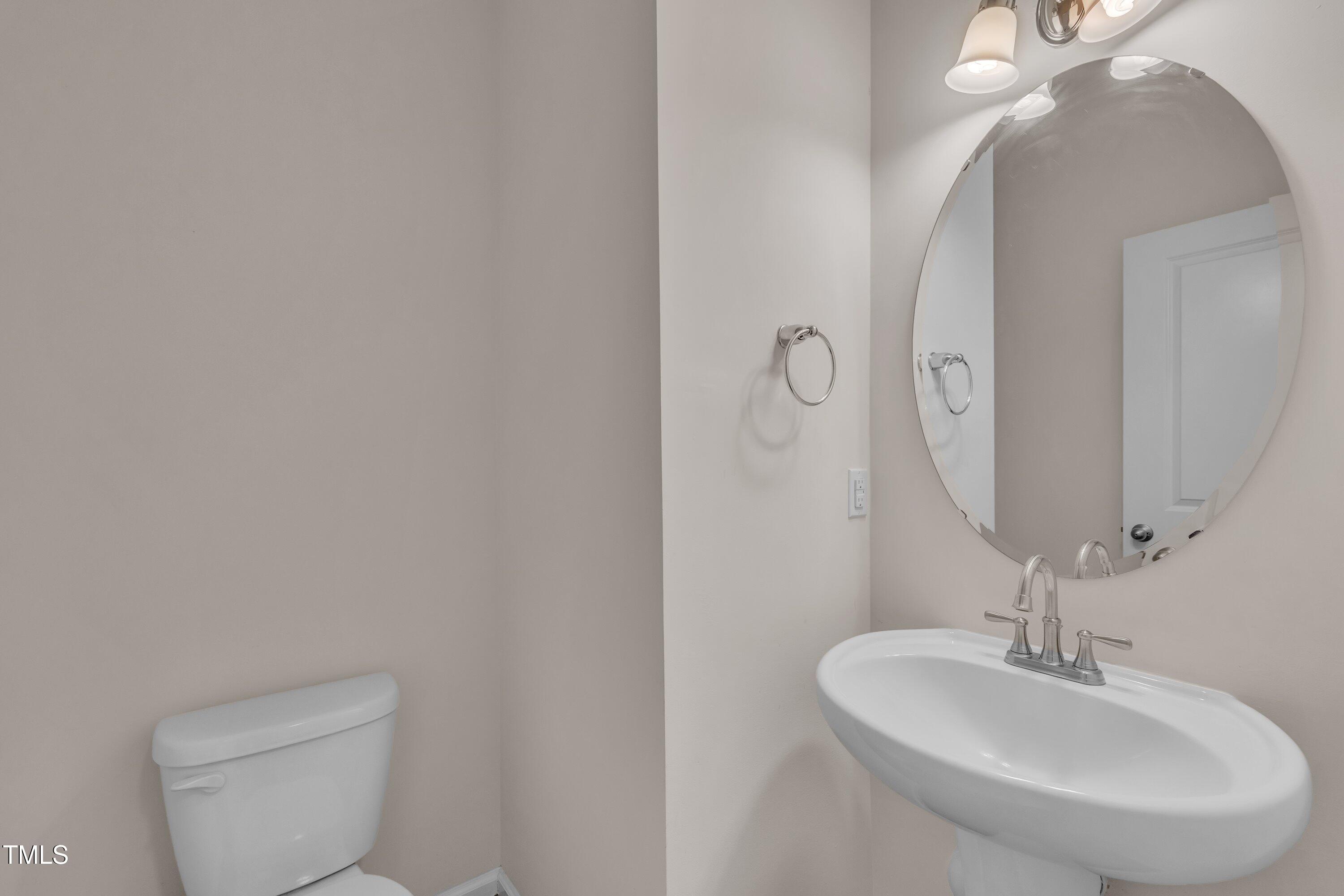 3519 Winding Walk Court Raleigh, NC 27616 - Photo 31 of 43 a bathroom with a sink a toilet and mirror