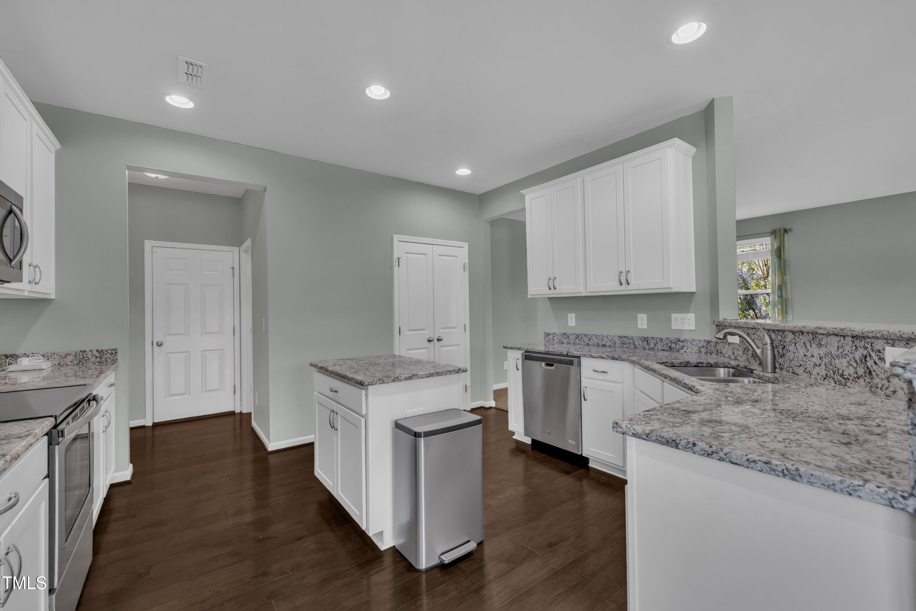 3519 Winding Walk Court Raleigh, NC 27616 - Photo 6 of 43 a kitchen with a sink stove and cabinets