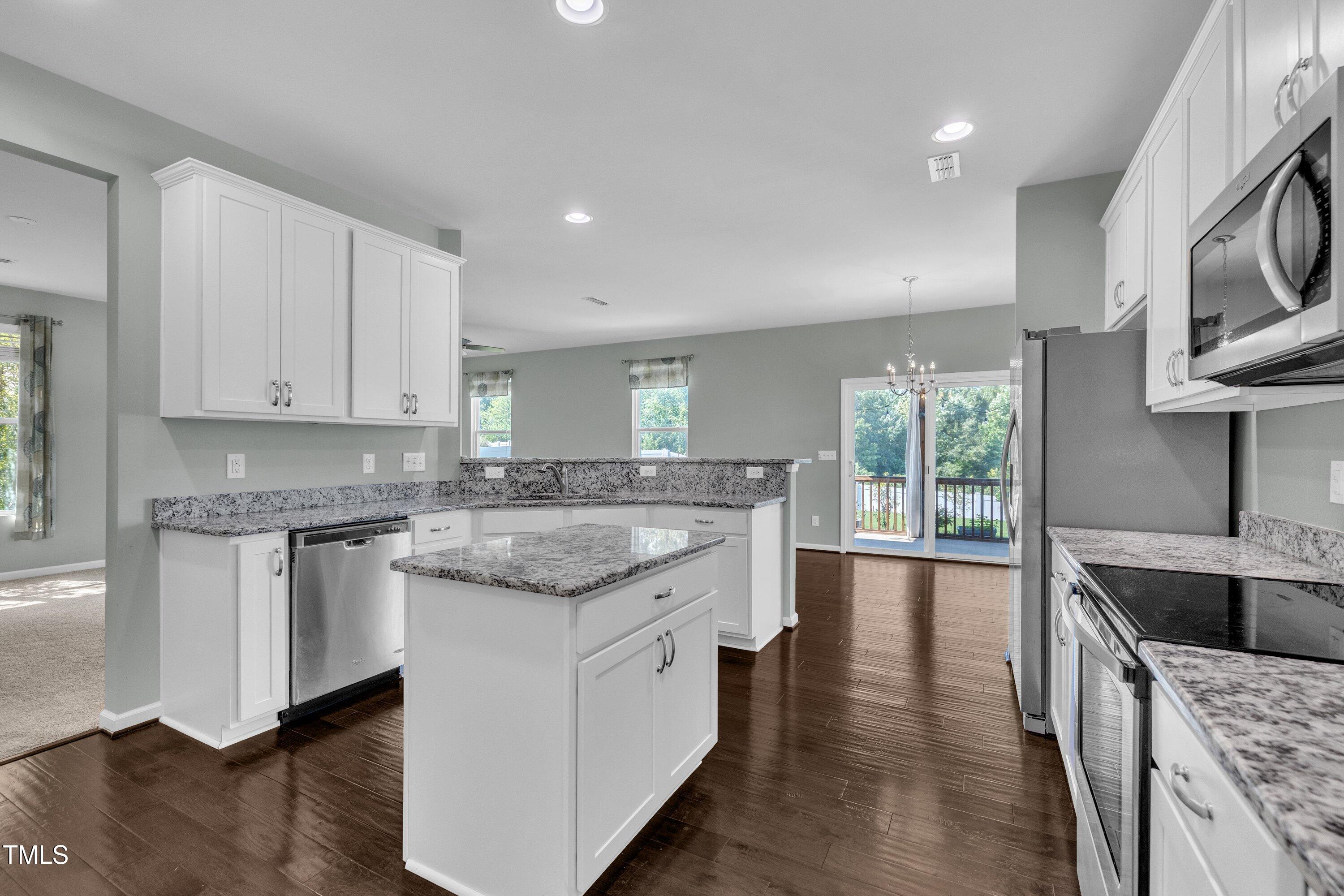 3519 Winding Walk Court Raleigh, NC 27616 - Photo 7 of 43 a kitchen with stainless steel appliances granite countertop a sink and stove top oven