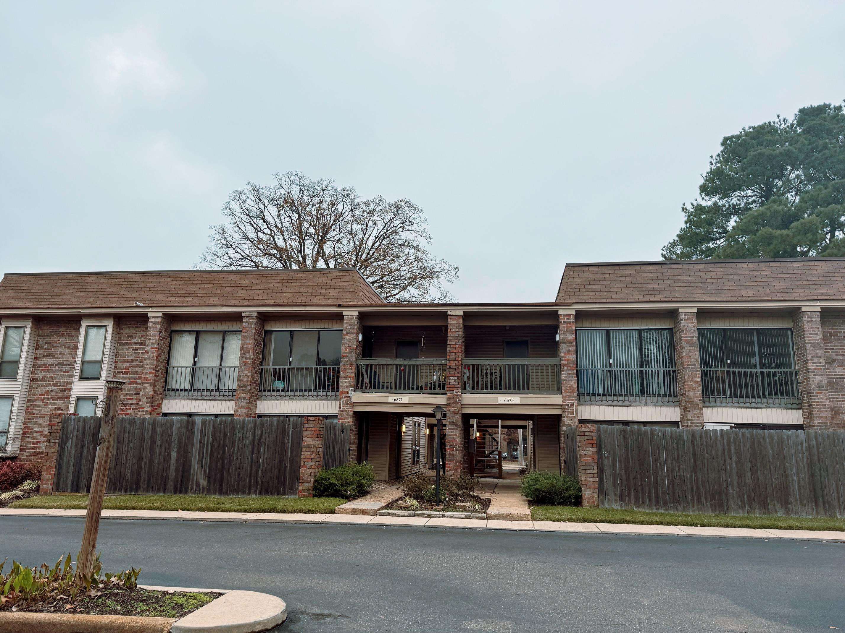 6571 Poplar Avenue, Unit 2 Germantown, TN 38138 - Photo 1 of 18 a front view of a house with garage