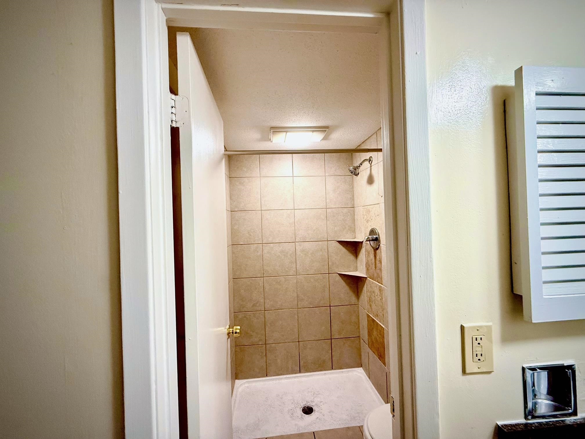 6571 Poplar Avenue, Unit 2 Germantown, TN 38138 - Photo 12 of 18 a bathroom with a shower and a sink