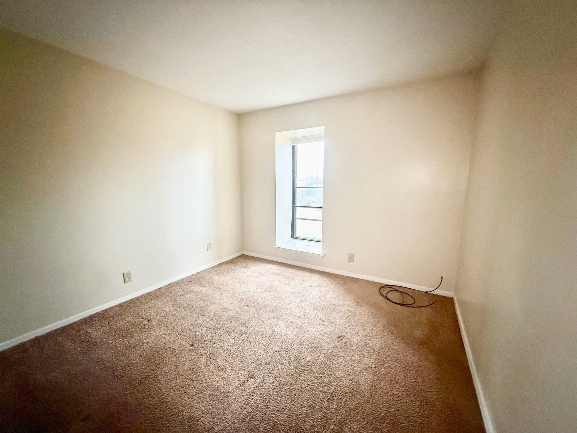6571 Poplar Avenue, Unit 2 Germantown, TN 38138 - Photo 14 of 18 an empty room with windows