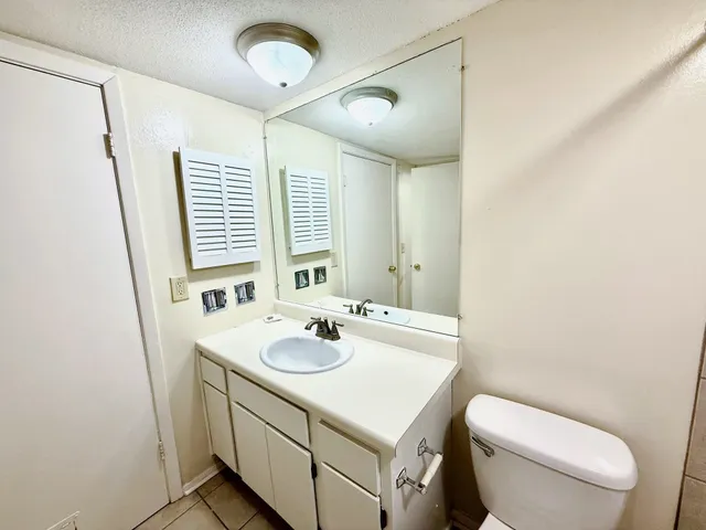 a bathroom with a sink toilet and window