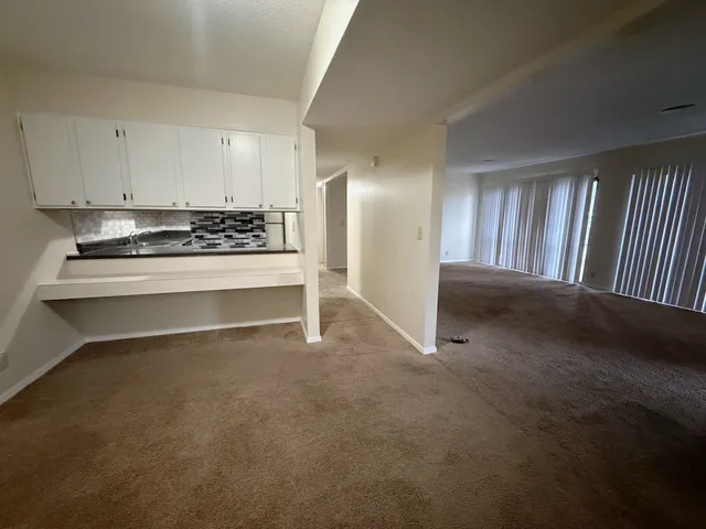 a view of a kitchen with a sink cabinets and a window