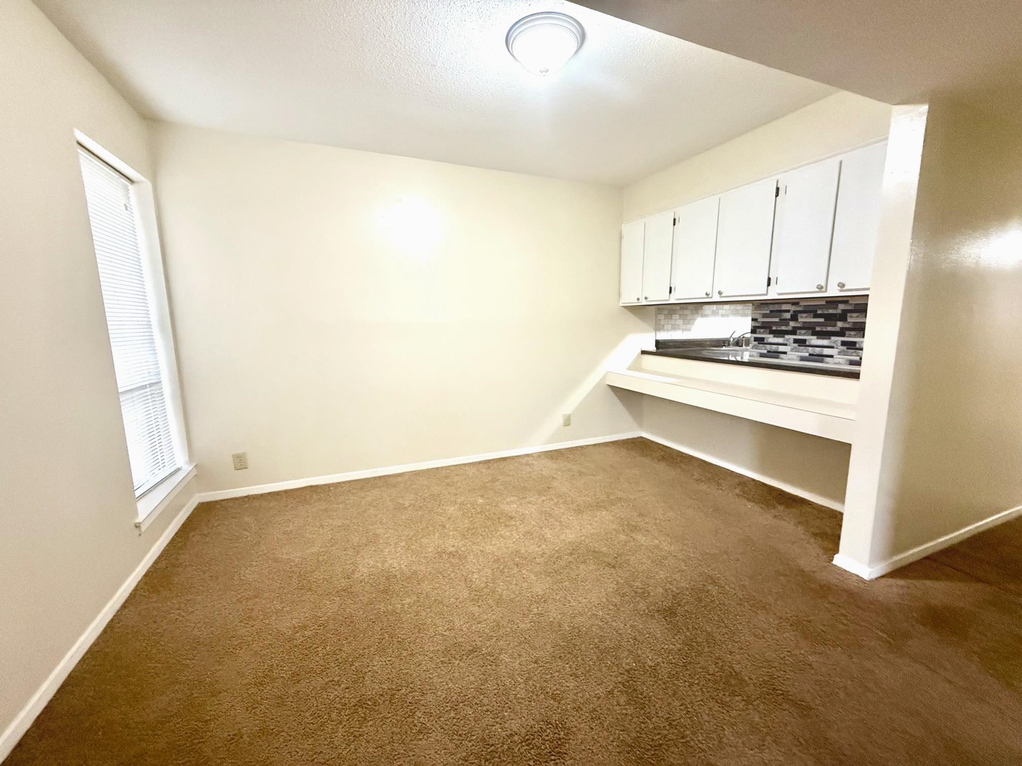 6571 Poplar Avenue, Unit 2 Germantown, TN 38138 - Photo 5 of 18 a view of an empty room with a window
