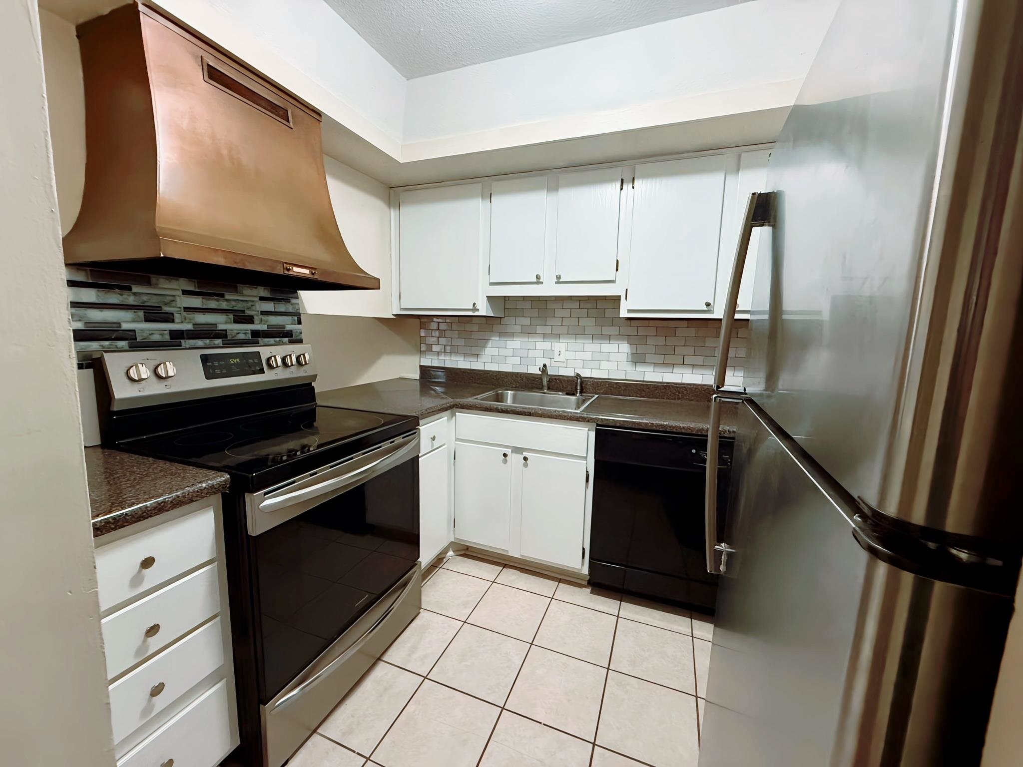 6571 Poplar Avenue, Unit 2 Germantown, TN 38138 - Photo 6 of 18 a kitchen with a stove sink and a refrigerator