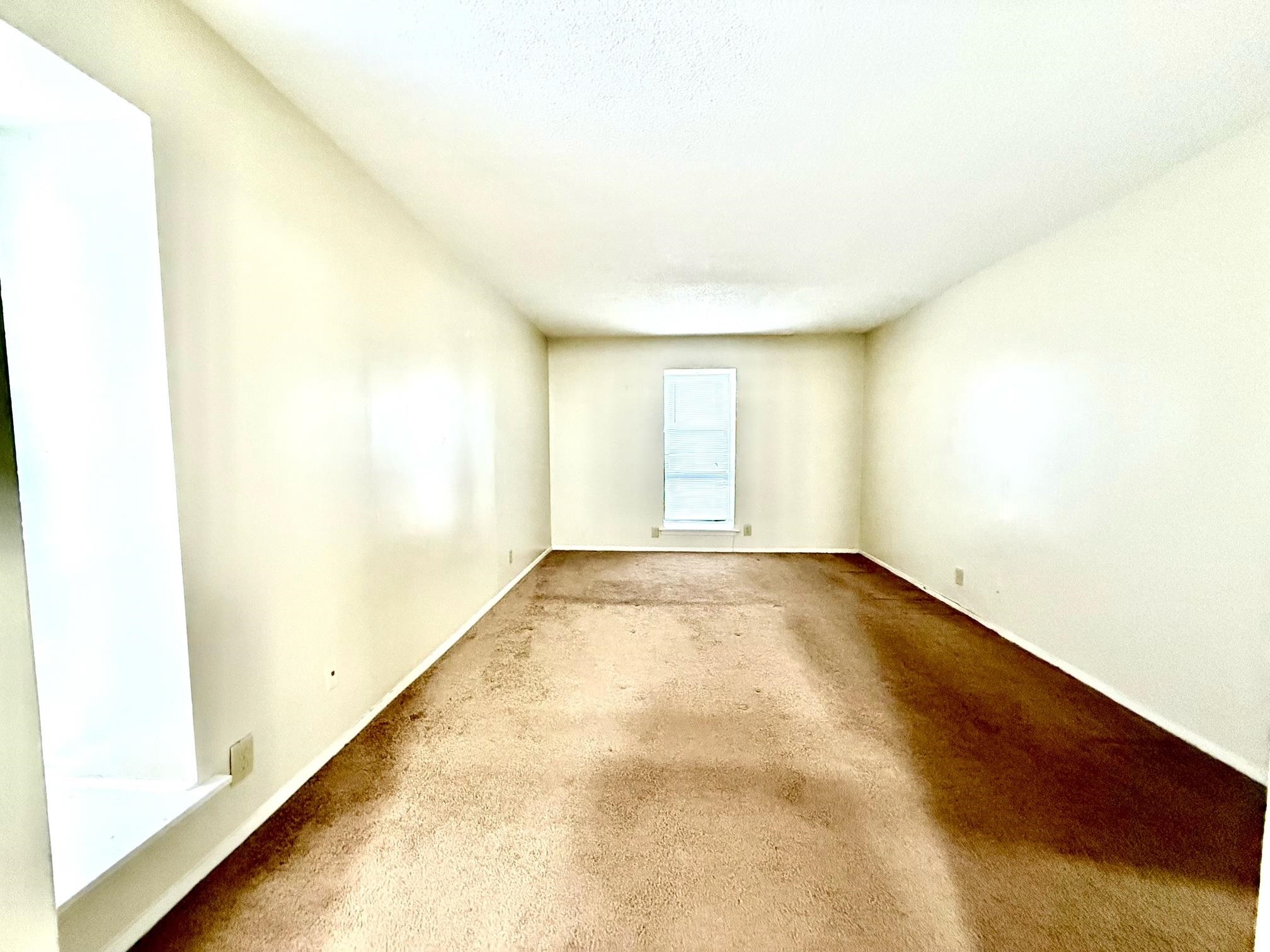 6571 Poplar Avenue, Unit 2 Germantown, TN 38138 - Photo 7 of 18 a view of an empty room and window