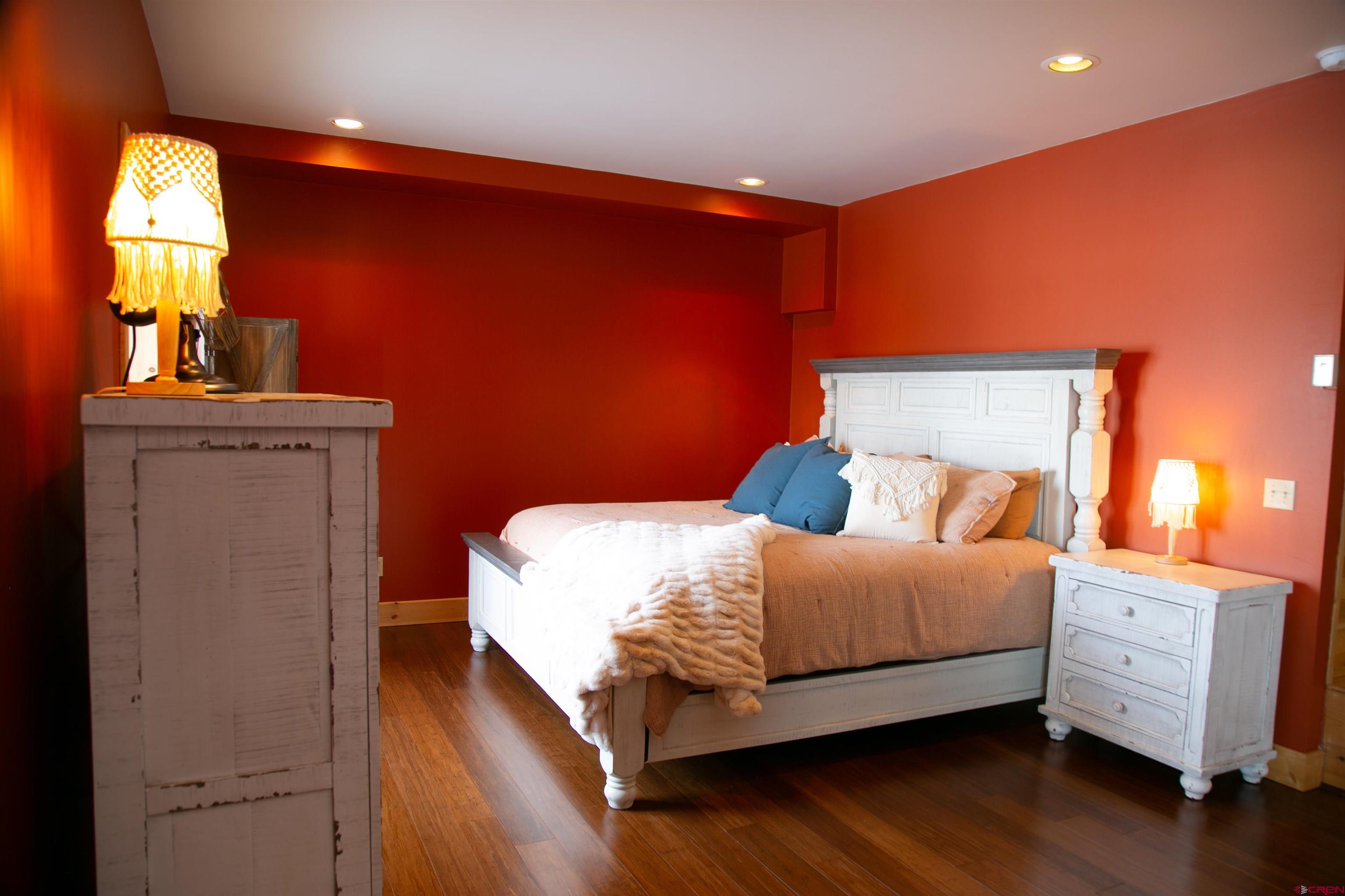 2250 Middle Creek Road Creede, CO 81130 - Photo 24 of 35 a bedroom with a bed and wooden floor