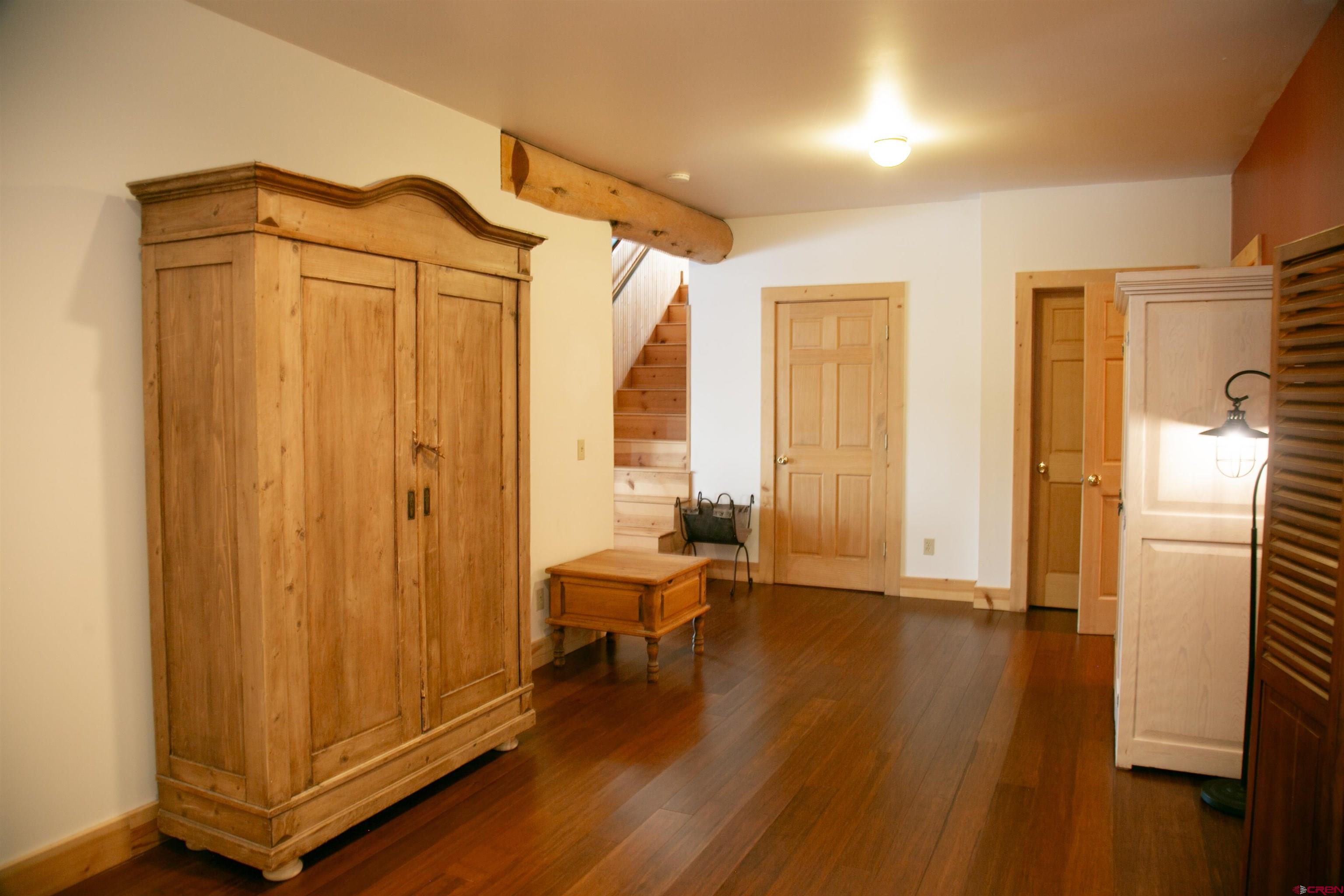 2250 Middle Creek Road Creede, CO 81130 - Photo 25 of 35 a view of a hallway with wooden floor and a bathroom
