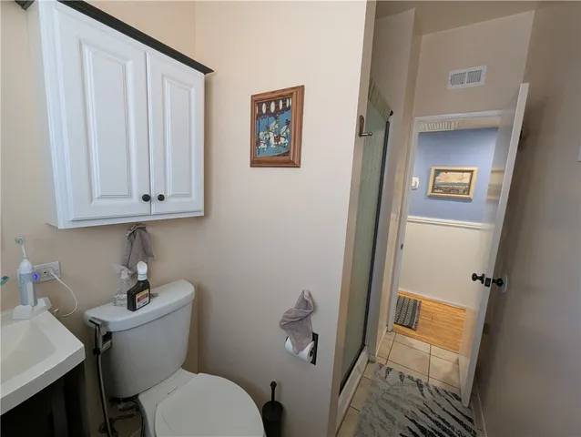 a bedroom with a bed and a flat tv screen on the dresser