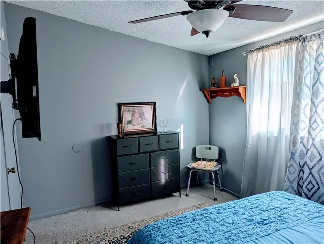 a bed sitting in a room next to a window