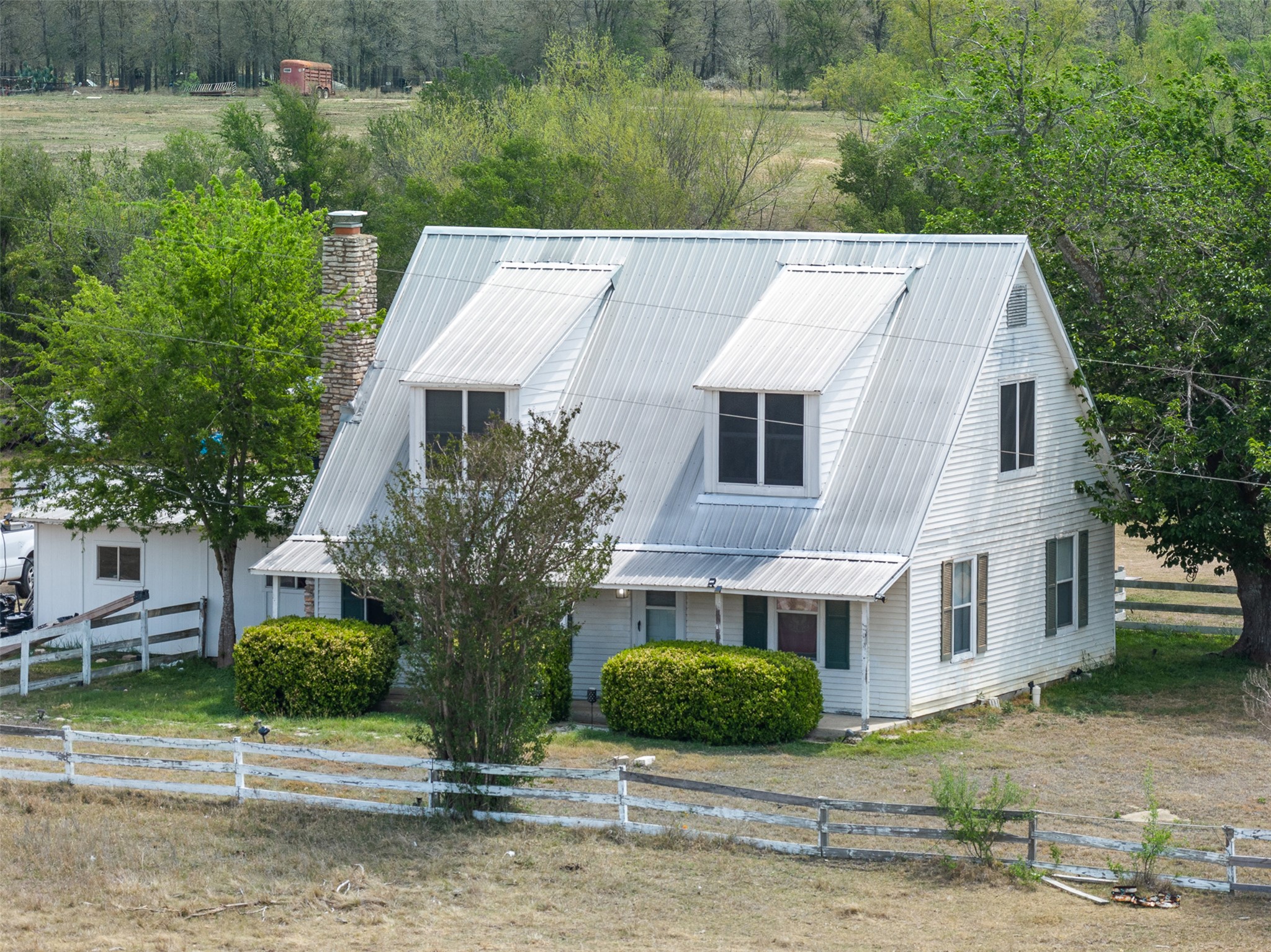 763 Upper Elgin River Road Elgin, TX 78621 - Photo 4 of 40 View of front of house featuring a metal roof and a chimney