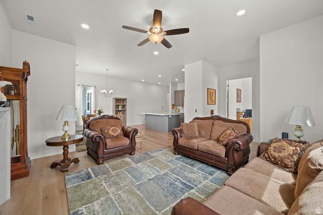 531 North Legend Way West, Unit D Mapleton, UT 84664 - Photo 7 of 42 Living room with light wood-style flooring, suspended lighting, and a ceiling fan