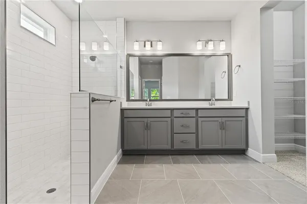 a bathroom with a sink a toilet and large mirror