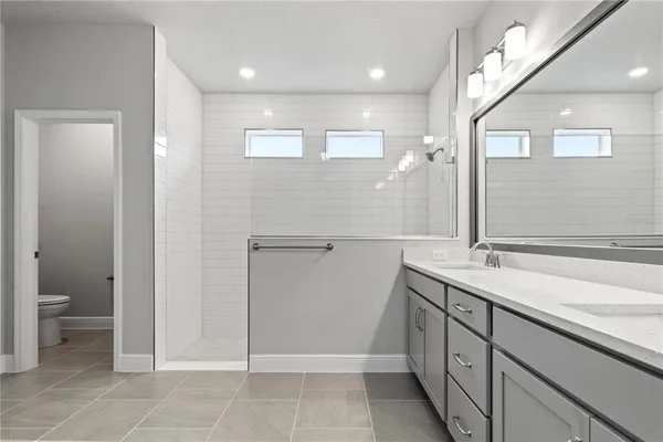 a bathroom with a shower and mirror