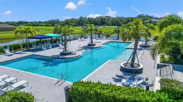 a view of a swimming pool with a table and chairs