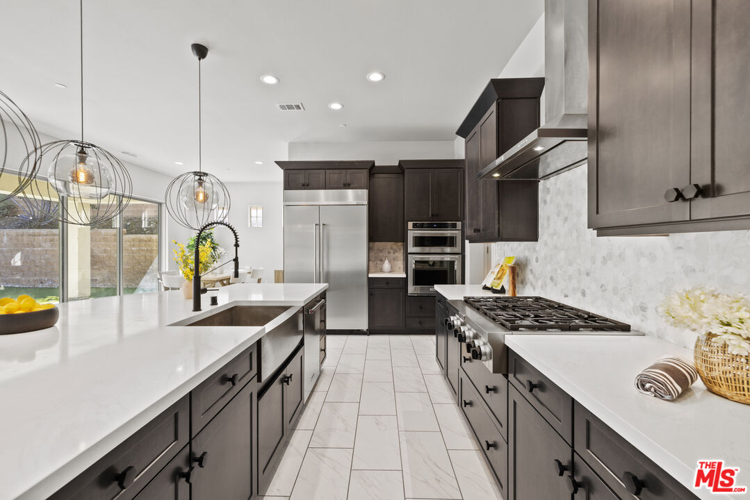 24220 Sterling Ranch Road West Hills, CA 91304 - Photo 2 of 39 a kitchen with stainless steel appliances a sink stove and cabinets