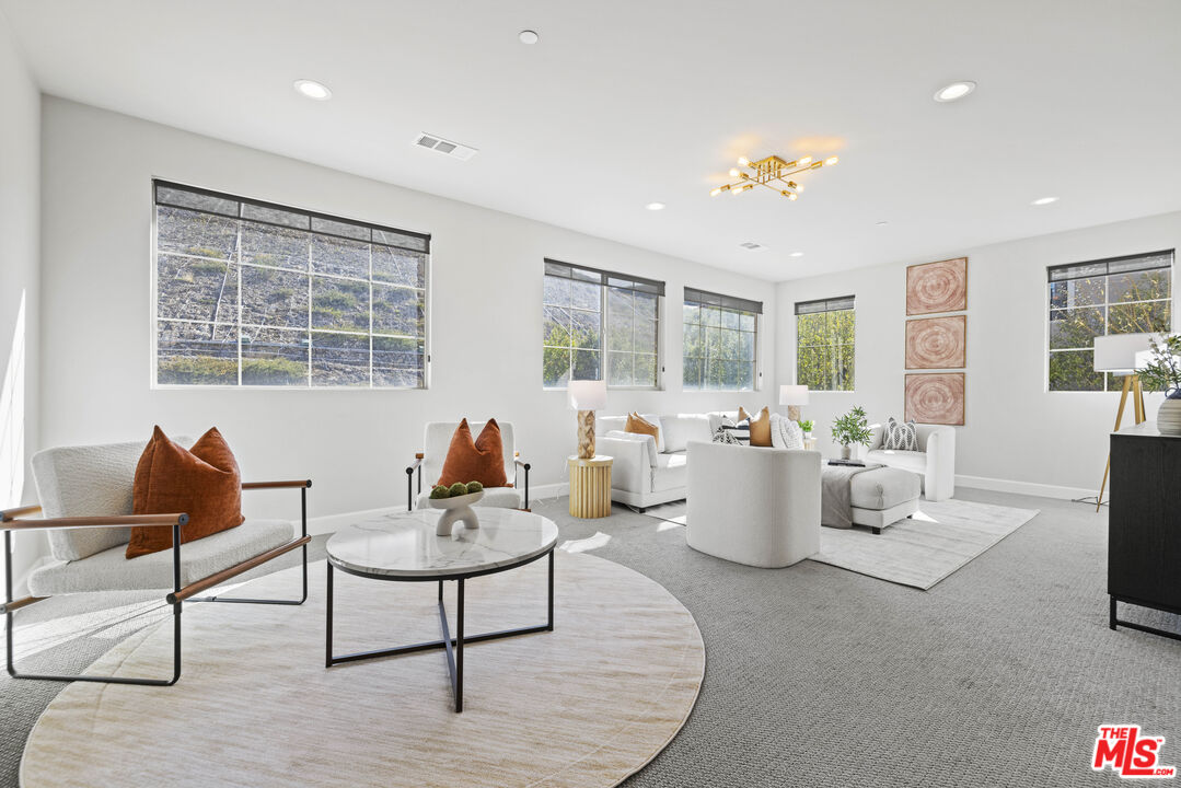 24220 Sterling Ranch Road West Hills, CA 91304 - Photo 24 of 39 a living room with furniture and windows