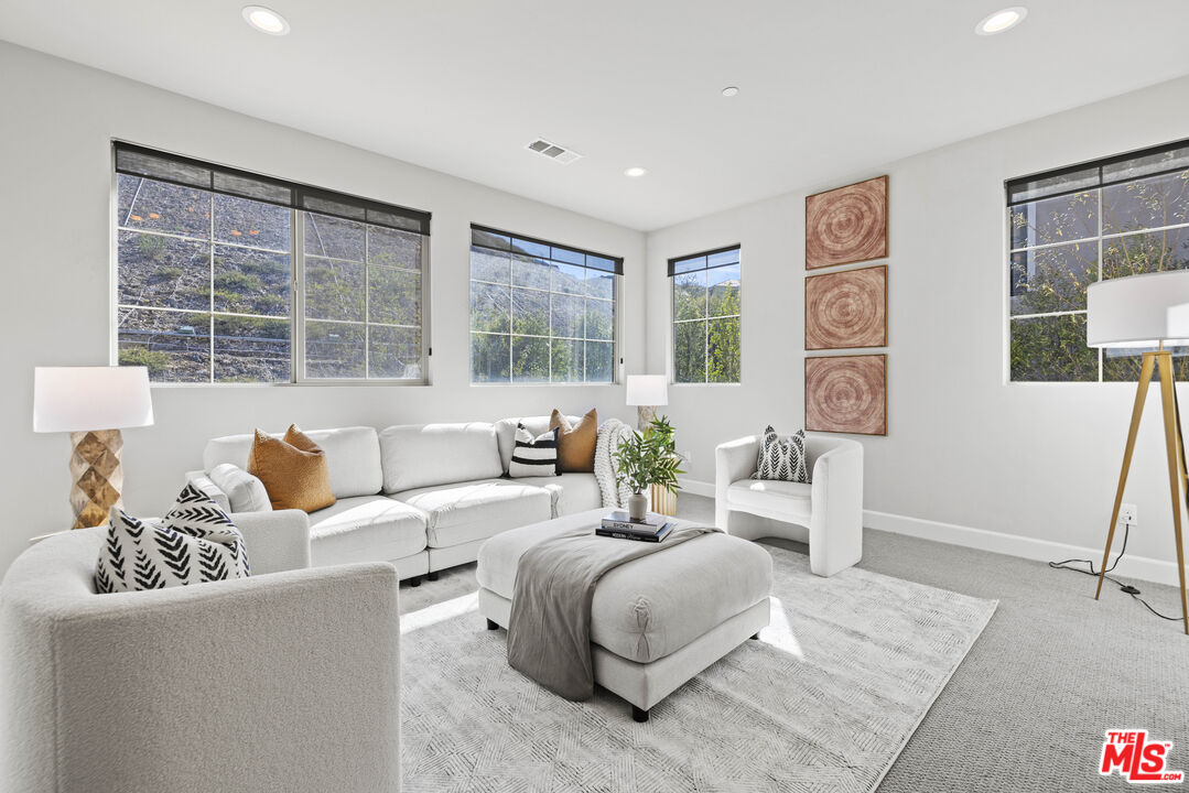 24220 Sterling Ranch Road West Hills, CA 91304 - Photo 25 of 39 a living room with furniture and a large window
