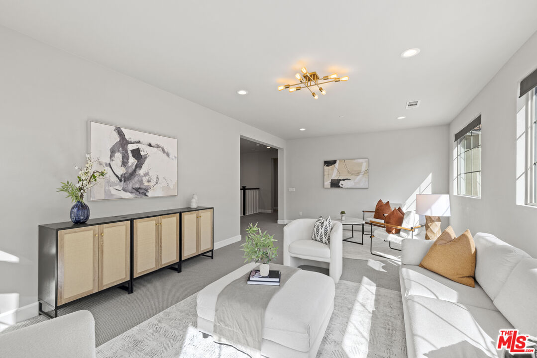 24220 Sterling Ranch Road West Hills, CA 91304 - Photo 26 of 39 a living room with furniture a table and chairs