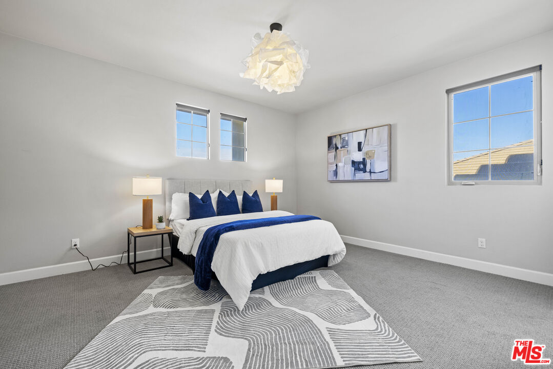 24220 Sterling Ranch Road West Hills, CA 91304 - Photo 28 of 39 a bedroom with a bed and a chandelier