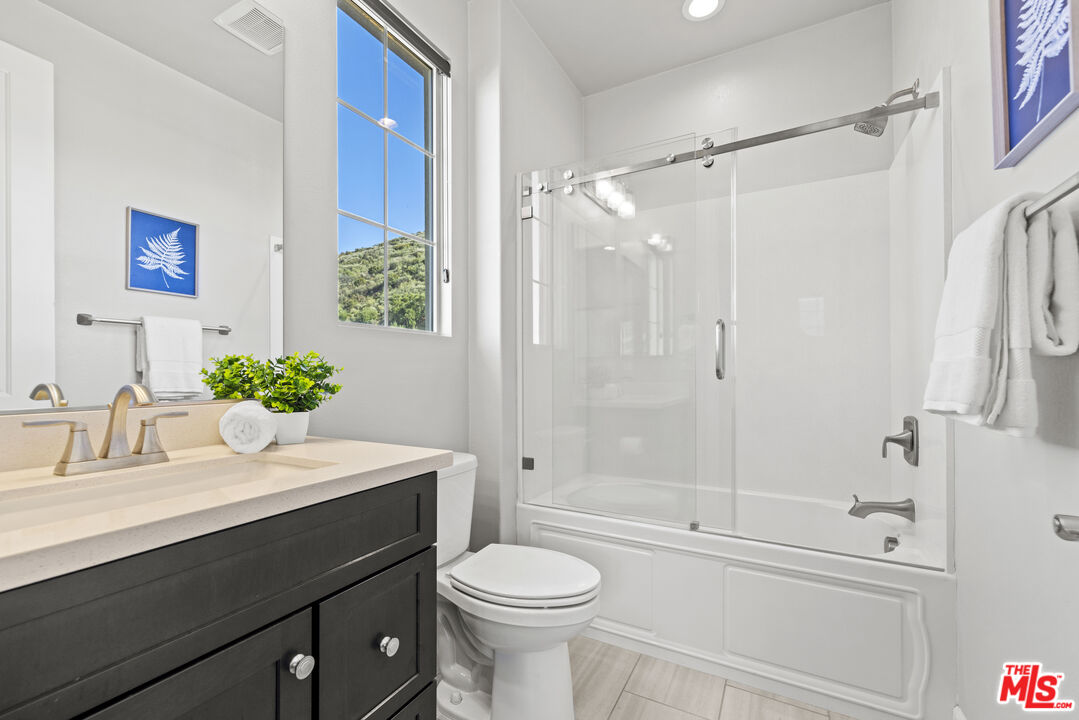 24220 Sterling Ranch Road West Hills, CA 91304 - Photo 30 of 39 a bathroom with a sink a toilet and shower