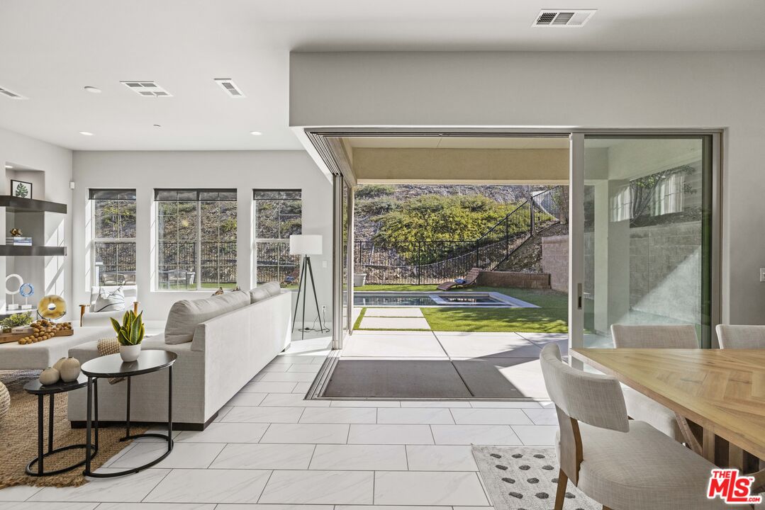 24220 Sterling Ranch Road West Hills, CA 91304 - Photo 4 of 39 a living room with a large window and furniture