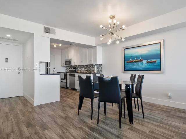 a kitchen with stainless steel appliances a sink stove and refrigerator