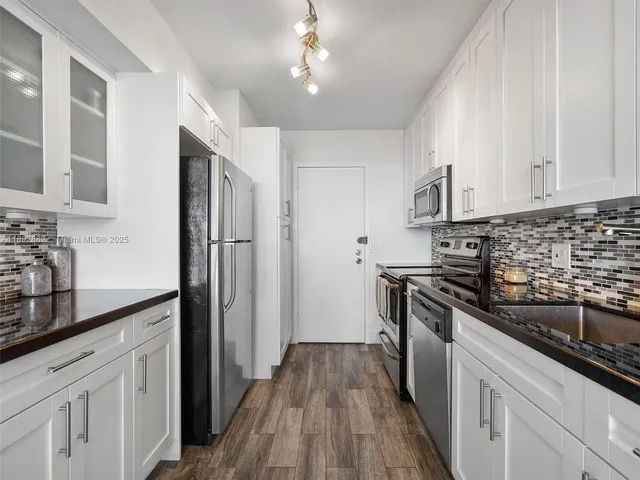 a kitchen with a refrigerator and a sink