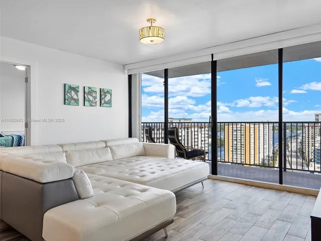 a view of a dining room with furniture a chandelier and wooden floor