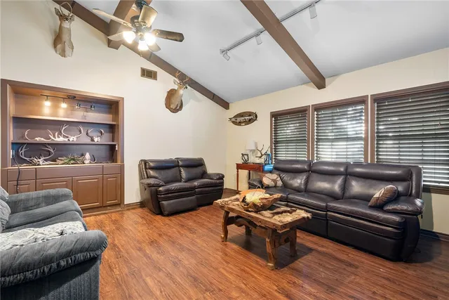 a living room with furniture fireplace and flat screen tv