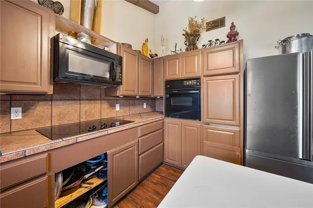 a bathroom with a granite countertop sink a mirror and shower