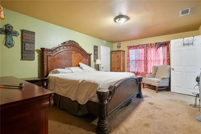 a bathroom with a granite countertop sink a mirror and shower
