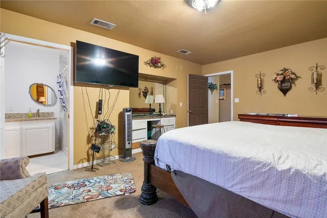 a utility room with dryer washer and a view of living room