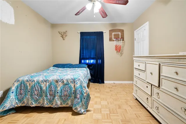 a bedroom with a bed and a chandelier