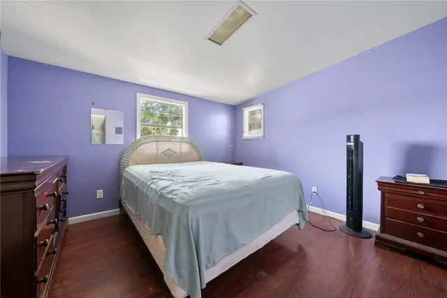 a front view of house with yard and trees in the background