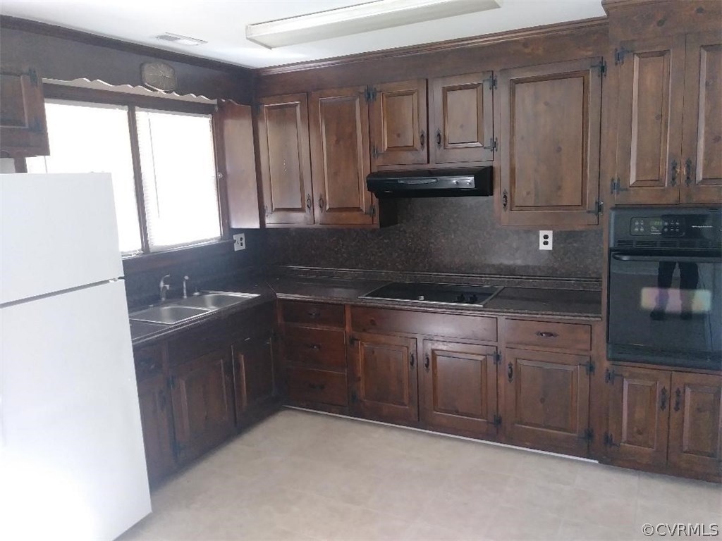 4126 Turner Road Chesterfield, VA 23832 - Photo 3 of 6 a kitchen with granite countertop a refrigerator sink and cabinets