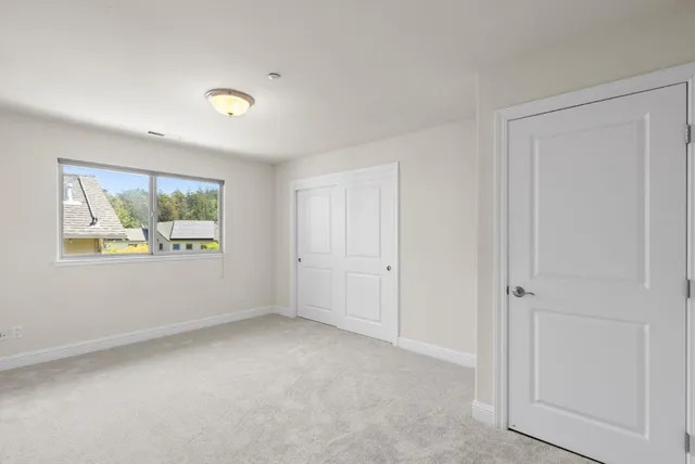 an empty room with windows and closet