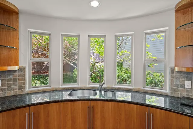 a view of a large window with kitchen view
