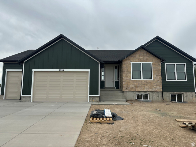 3839 West 825 North, Unit WF18 West Point, UT 84015 - Photo 1 of 22 Contemporary exterior featuring dark green vertical siding and light-toned stone accents