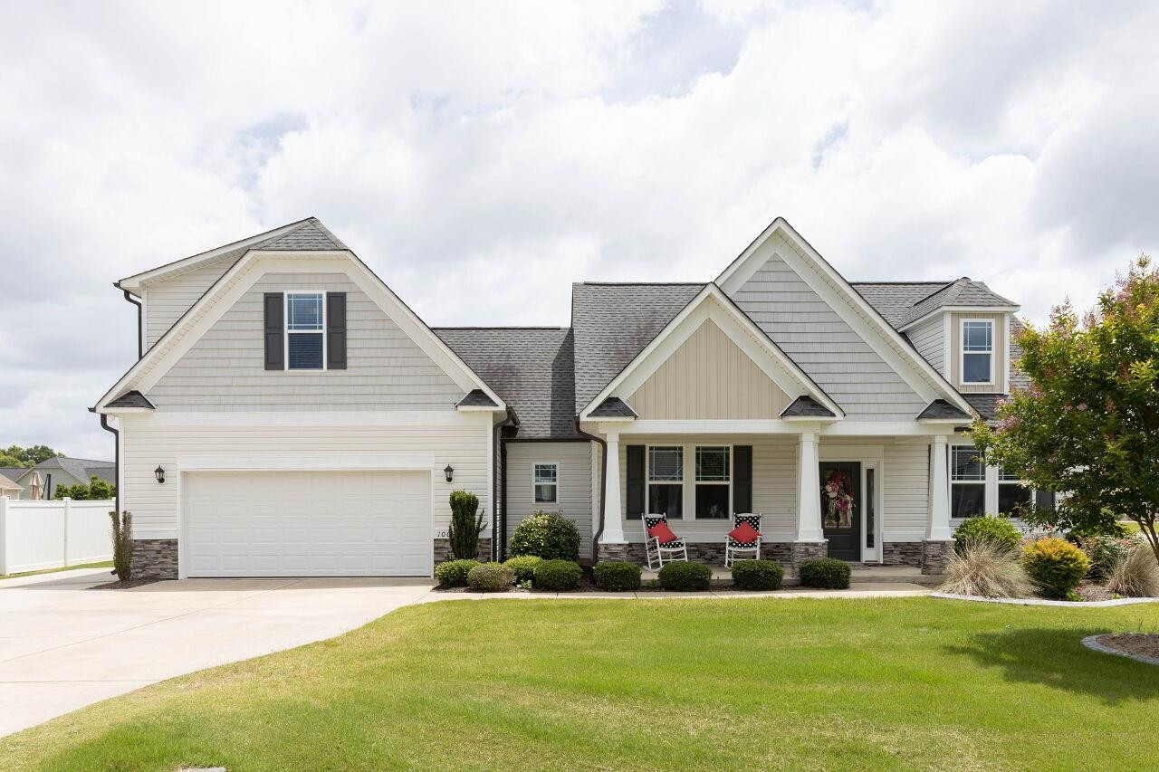 a front view of a house with a yard and garage