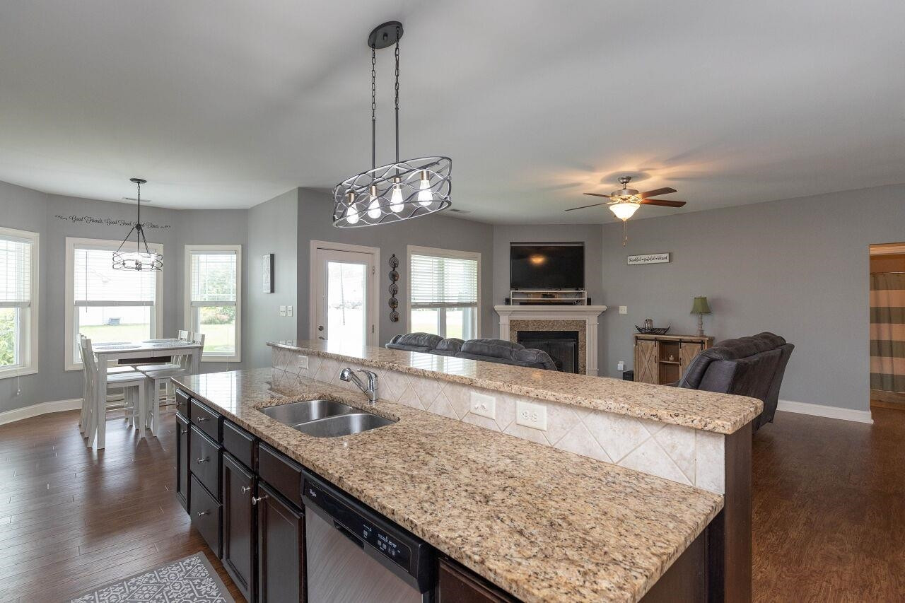 100 Celestial Drive Garner, NC 27529 - Photo 12 of 31 a view of living room kitchen island dining table and chairs