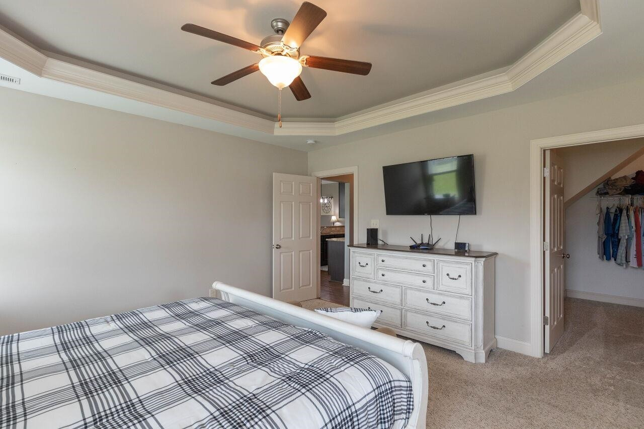 100 Celestial Drive Garner, NC 27529 - Photo 15 of 31 a bedroom with a bed a flat screen tv and dresser