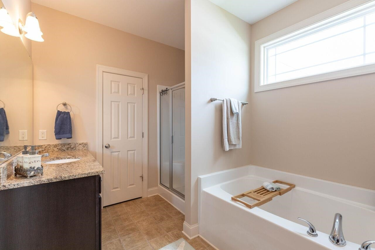 100 Celestial Drive Garner, NC 27529 - Photo 16 of 31 a bathroom with a tub sink and mirror